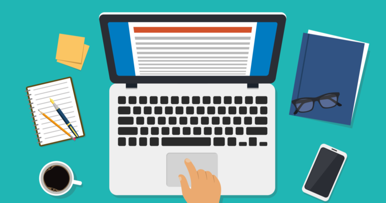 A right hand is scrolling through the mouse pad of a laptop, which is next to a notebook with a pen, a cup of coffee, a sticky note, a phone, and a planner.